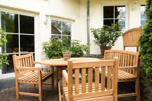 a wooden table and chairs on a patio at Ferienhof Homann Sauerland in Brilon