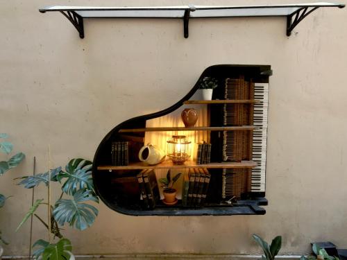 a window in a wall with a book shelf at Baloo Hostel in Athens
