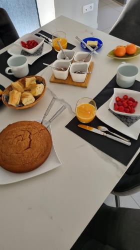 a white table with food on top of it at Les Moineaux de Crussol in Guilherand