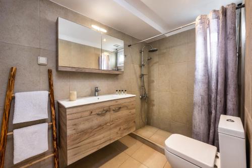 a bathroom with a sink and a toilet and a mirror at George Apartments2 in Vóthon