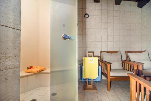 two views of a room with chairs and a table at Samonas - Green villa Faskomilia in Chania Town