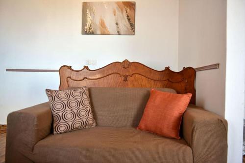 a brown couch with pillows on top of it at Haven in Hydra