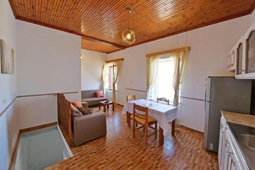 a kitchen and living room with a table and a couch at Haven in Hydra