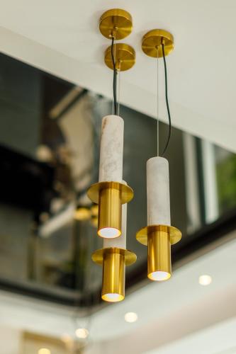 a group of three lights hanging from a ceiling at Onal Boutique Hotelier in Mamaia