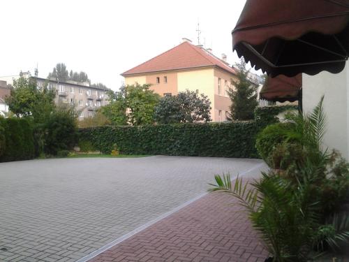 a brick courtyard with a building in the background at Penzion Ema B&B in Prostějov