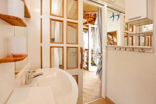 a bathroom with a white sink and a mirror at Robinson Corto Maltese in Bol