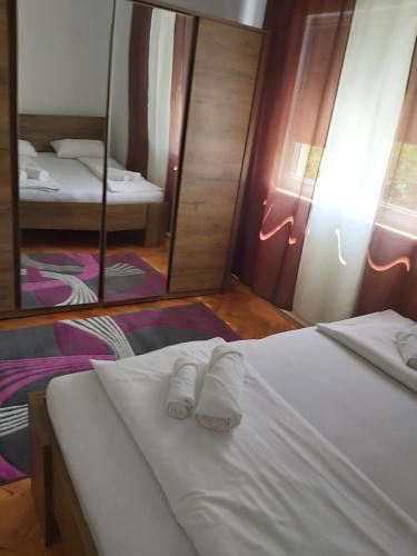 a bedroom with a bed with two towels on it at Šadrvan Una Apartment in Bihać