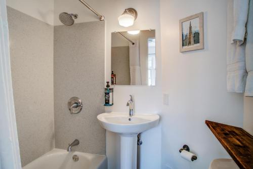 a bathroom with a sink, mirror, and bathtub at The Bartlett Hotel and Guesthouse in San Francisco
