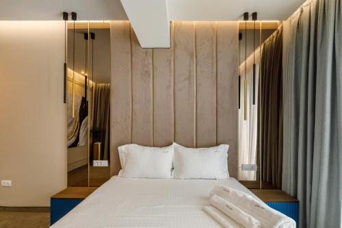 a bedroom with a bed with two white pillows at Onal Boutique Hotelier in Mamaia