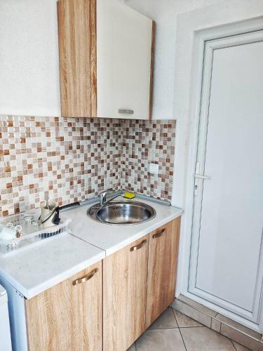 a kitchen with a sink and a counter top at Apartments Iva in Star Dojran