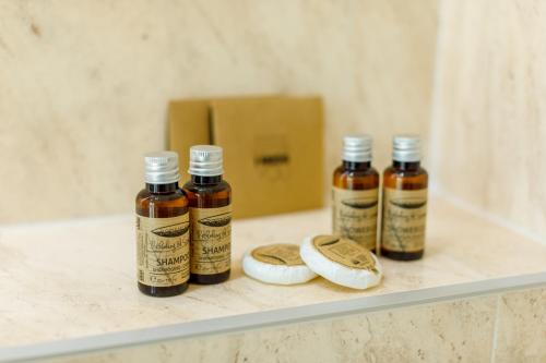 three bottles of essential oils sitting on a shelf at Onal Boutique Hotelier in Mamaia