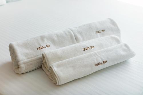 two rolled up white towels sitting on a table at Onal Boutique Hotelier in Mamaia