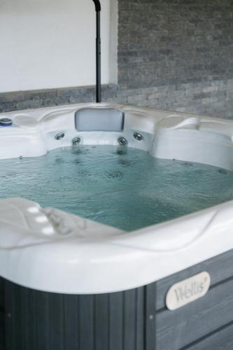 a bath tub filled with water in a bathroom at Flow House&Garden in Badacsonytomaj