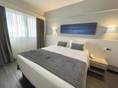 Ein Bett oder Betten in einem Zimmer der Unterkunft Mercure Camboriu