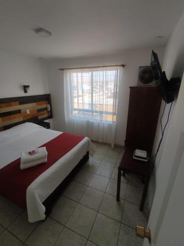 Una cama o camas en una habitación de Hotel Andalucía