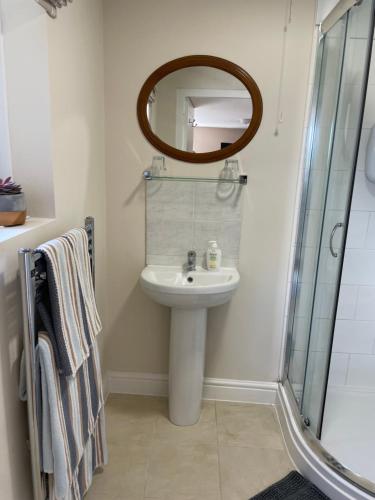 a bathroom with a sink and a mirror at Hideaway in Bradford on Avon