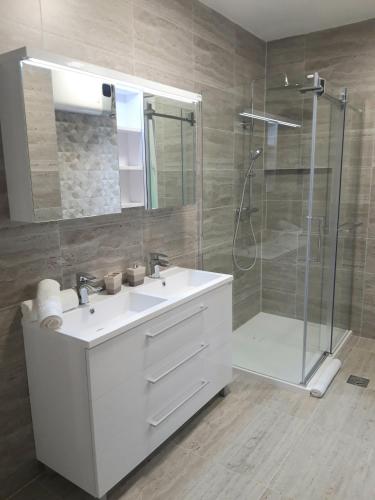 a bathroom with a white sink and a shower at Apartments Darijana in Opatija