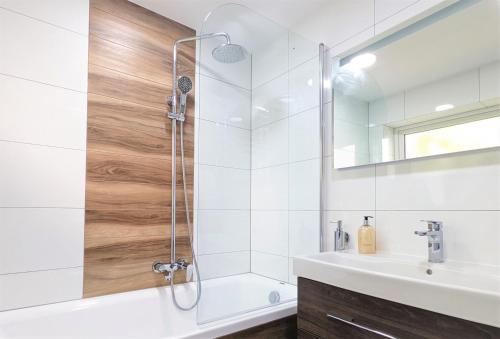 a bathroom with a shower and a sink at Pointe South in Ventnor