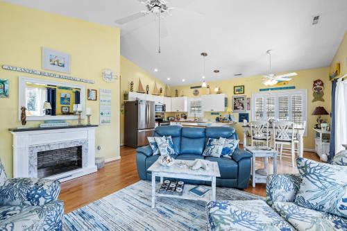 a living room with a blue couch and a fireplace at On Island Time in Atlantic Beach