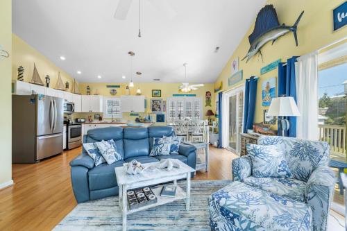 a living room with a blue couch and a table at On Island Time in Atlantic Beach
