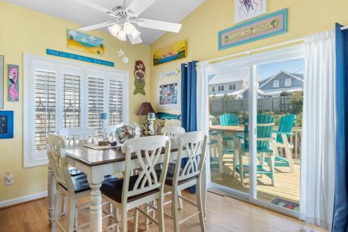 a dining room with a table and chairs at On Island Time in Atlantic Beach