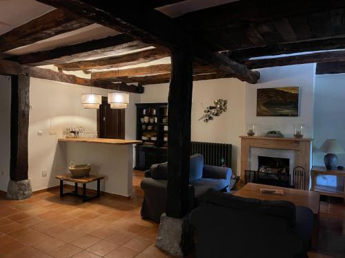a living room with two couches and a fireplace at El Jardin de las Magnolias Hotel in Quintana de Soba