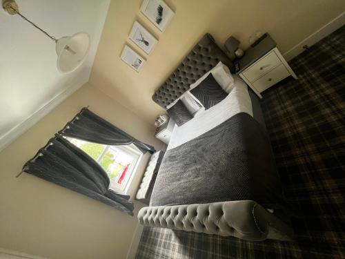 a bedroom with a large bed in a room at The Village Inn in Carstairs