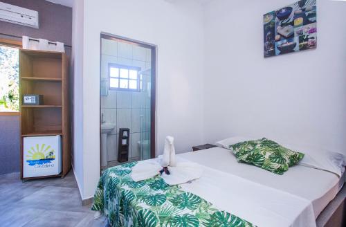 a bedroom with a bed with a flower on it at Pousada Castelinho in São Sebastião