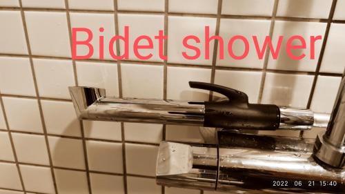 a bird shower sign on a tiled bathroom wall at HaPPy Inn Laime Studio, Self Check-In-24-7, A-C, Parking-in-the-underground-Garage in Vilnius