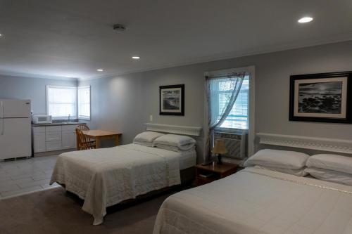 מיטה או מיטות בחדר ב-Beach Walk Hotel
