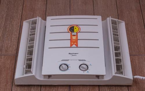 a large appliance is sitting on a wooden floor at Pousada Castelinho in São Sebastião