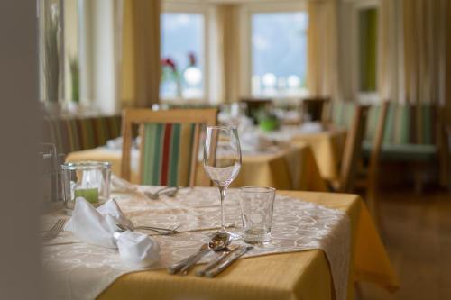 a table with two wine glasses on a white table cloth at Alpinresort Schillerkopf in Bürserberg