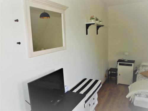 a room with a mirror and a tv on a wall at Resort LUFT Sněžník in Sněžnik