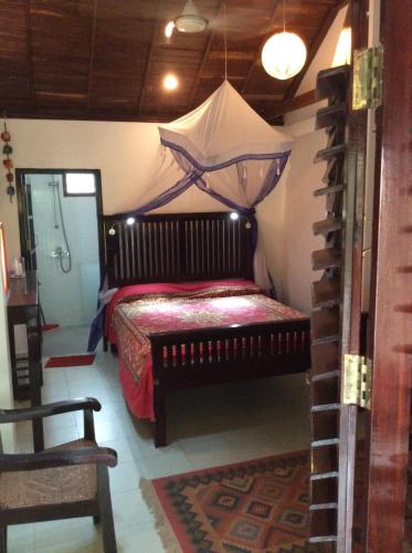 a bedroom with a bed with a canopy at Maharaju Palace in Kovalam