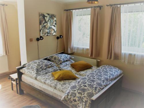 a bedroom with a bed with two pillows on it at Resort LUFT Sněžník in Sněžnik