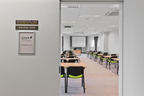 an empty classroom with desks and chairs in a room at Green Vilnius Hotel in Vilnius