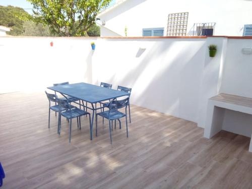 a blue table and chairs on a patio at Delightful Villa close to the beach in L'Escala