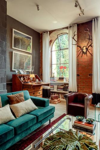 a living room with a green couch and a table at Lisbon Unique Apartments in Lisbon