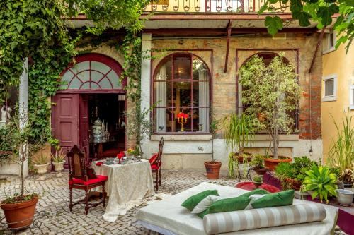 an outdoor patio with a table and a bed at Lisbon Unique Apartments in Lisbon