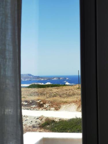 a view of the ocean from a window at Κallisto rooms in Mytakas