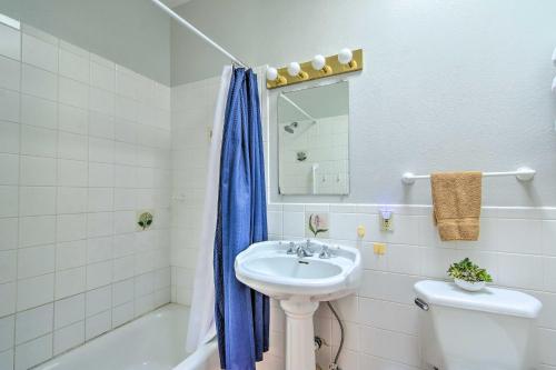 a bathroom with a sink and a toilet and a mirror at Tranquil Eloy Apartment with Oasis Courtyard! in Eloy