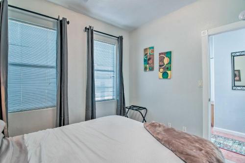 a bedroom with a bed and two large windows at Tranquil Eloy Apartment with Oasis Courtyard! in Eloy