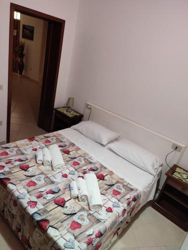 a bed with towels and flip flops on it at Le Due Palme in Marsala