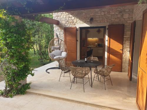 a patio with a black table and chairs at Villa Valeria in Divšići