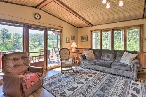 a living room with a couch and two chairs at Creekside Rapid City Cabin with Deck on 30 Acres! in Rapid City