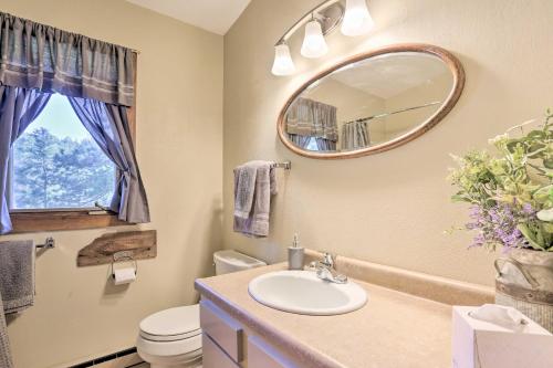 a bathroom with a sink and a mirror at Creekside Rapid City Cabin with Deck on 30 Acres! in Rapid City