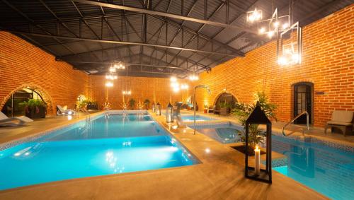 a large swimming pool in a brick building at Quindeloma Art Hotel & Gallery in Riobamba