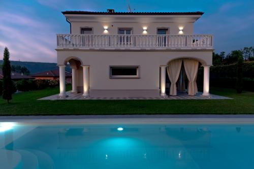 a house with a pool in front of it at Villa San Martino in Albiano dʼIvrea