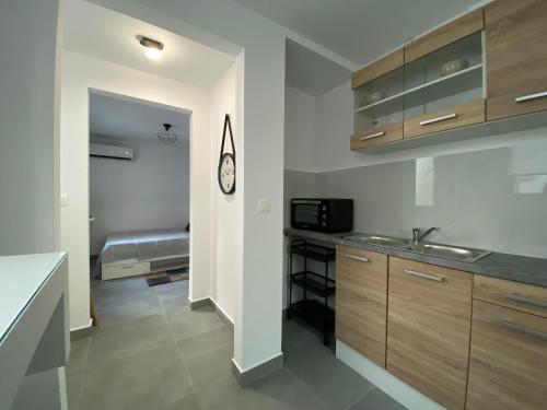 a kitchen with a sink and a microwave at Tiny Little House in Athens