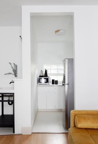 a kitchen with white cabinets and a refrigerator at Kettle Valley Beach Resort in Penticton